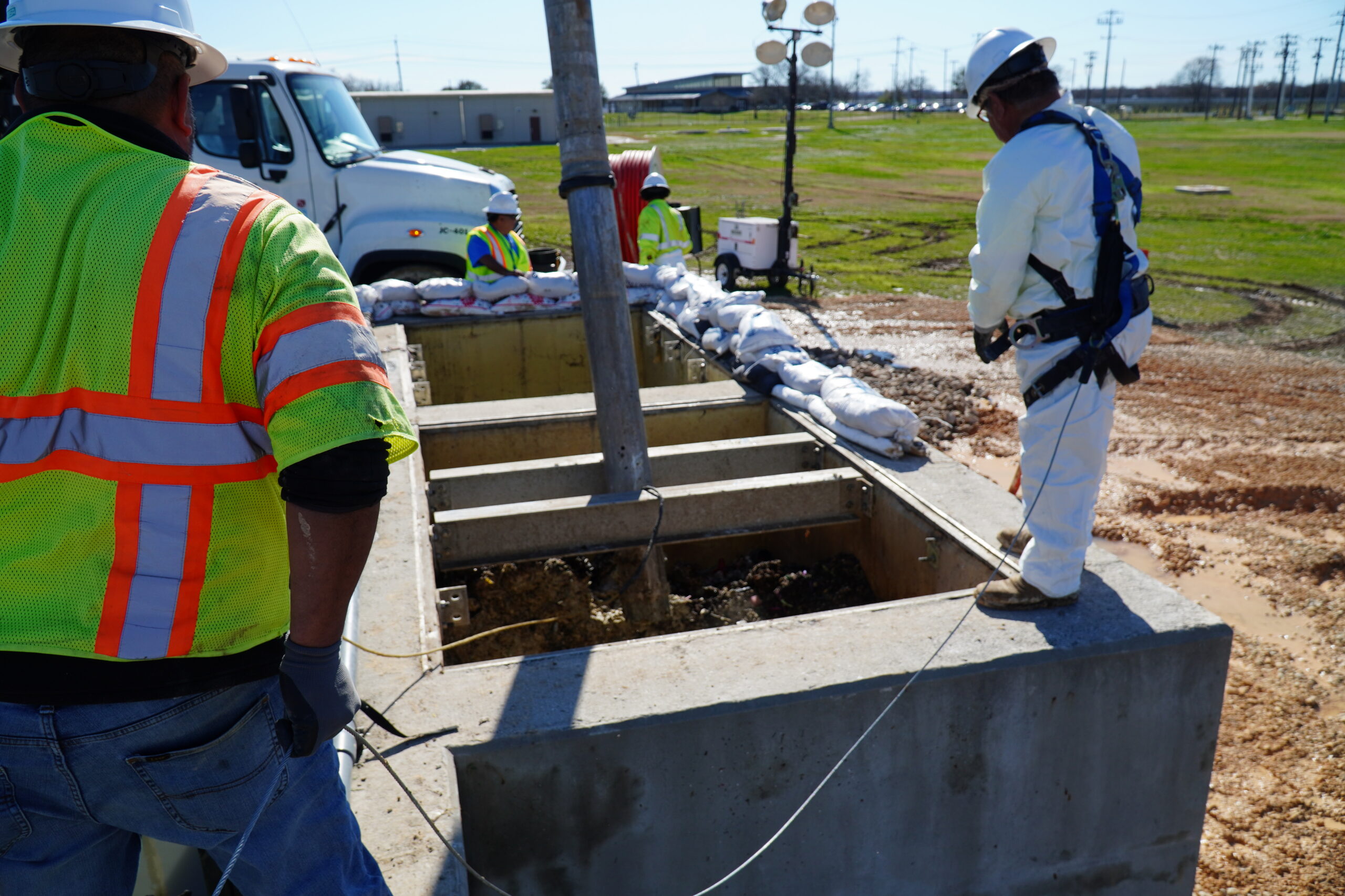 SAWS employees working to dislodge grease build up at Clouse Water Recycling Plant